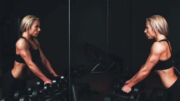 gym-mirrors-athlete-woman-looking-at-herself